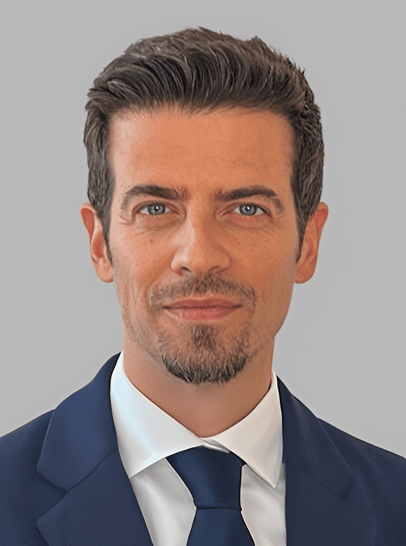 Professional headshot of a man in a suit and tie.